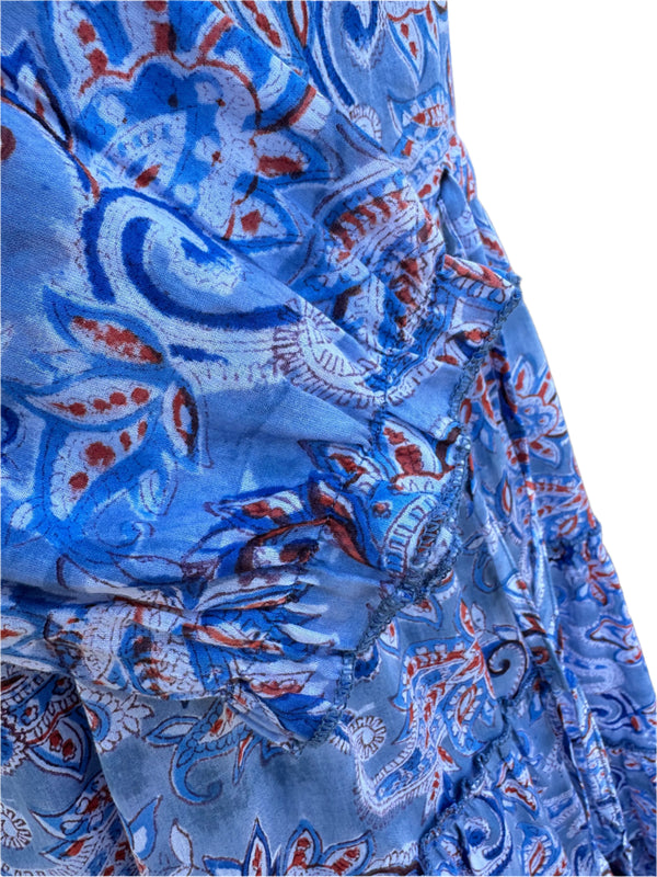 the image has a soft blue base color with orange, white, and navy blue paisley patterns