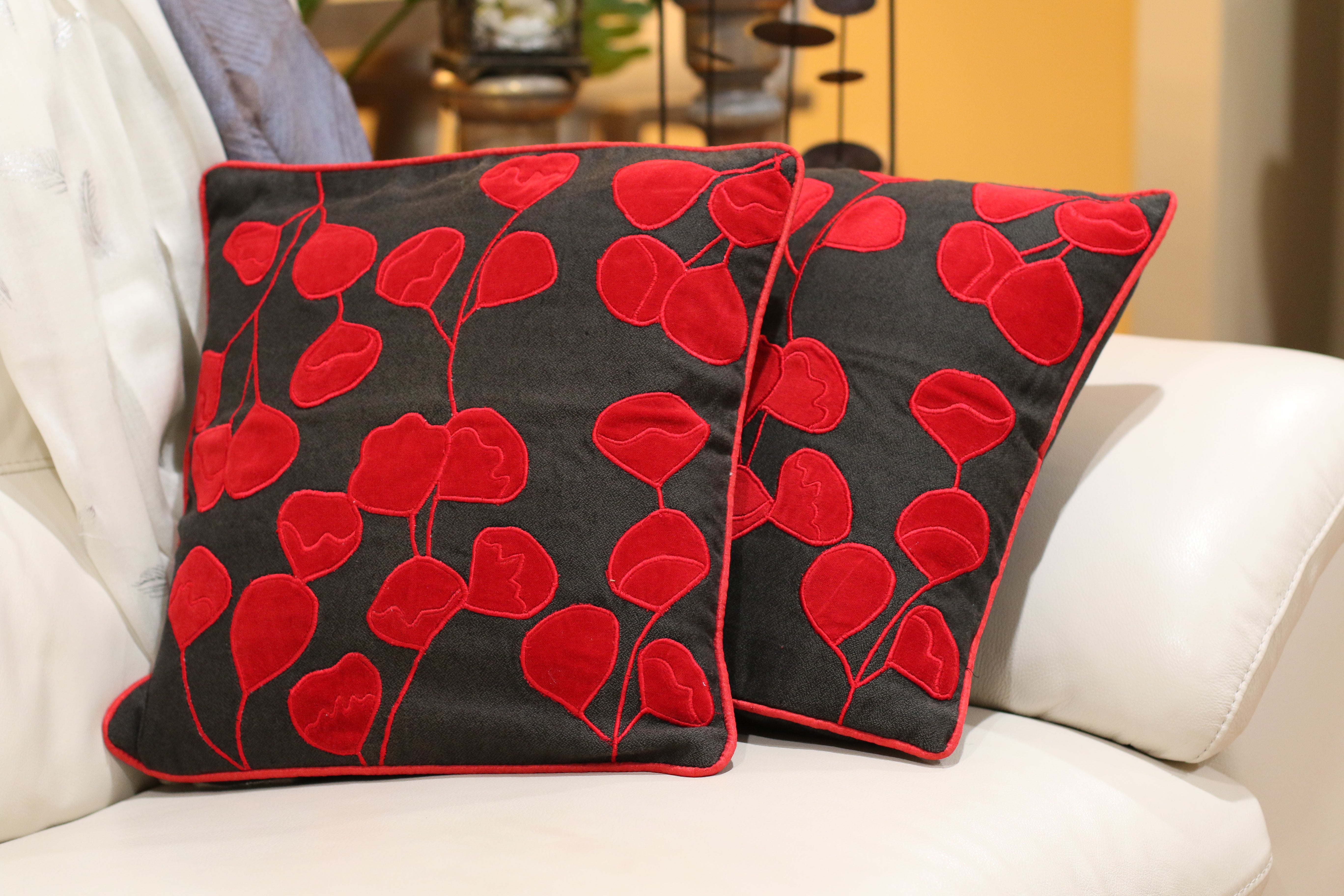 Set of handmade pillow in black base with red applique floral pattern
