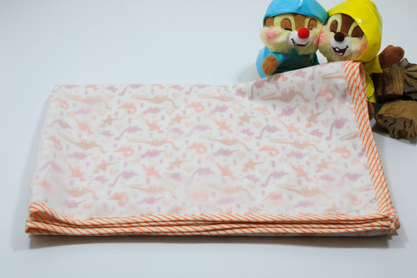 Soft cotton hand-block dinosaur baby blanket with orange border