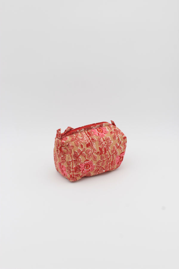 Beige and red floral hand stamped make up bag with two inside pockets.